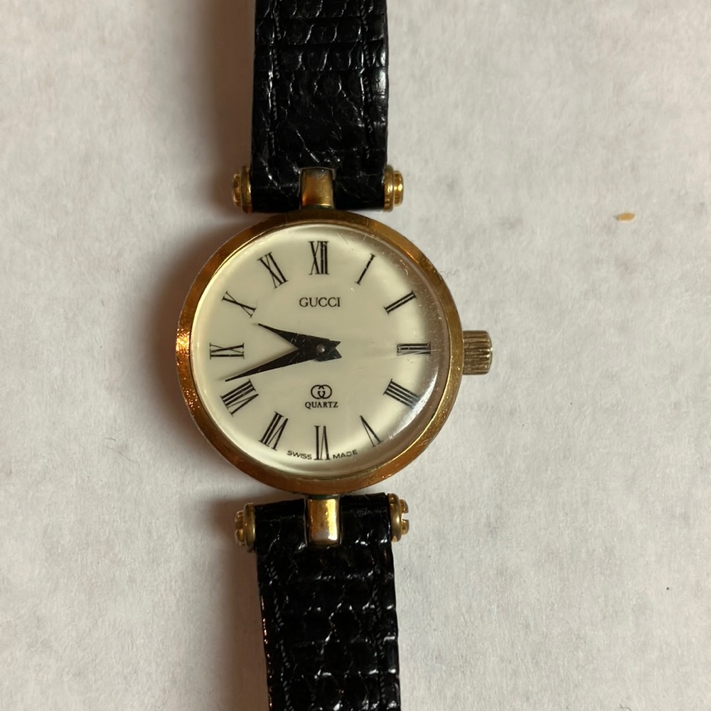 Gucci gold and black watch.